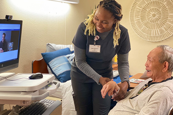 Nurse helping patient with telehealth