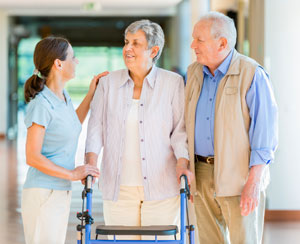 caregiver talking with elderly couple