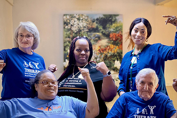 Nexion employees and patients posing with strong arms