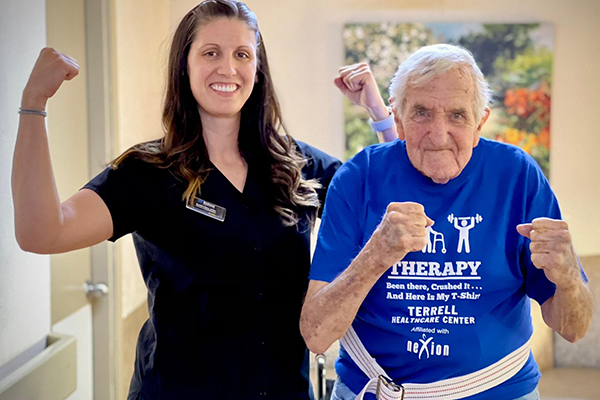 Nexion employee and elderly patient posing with strong arms