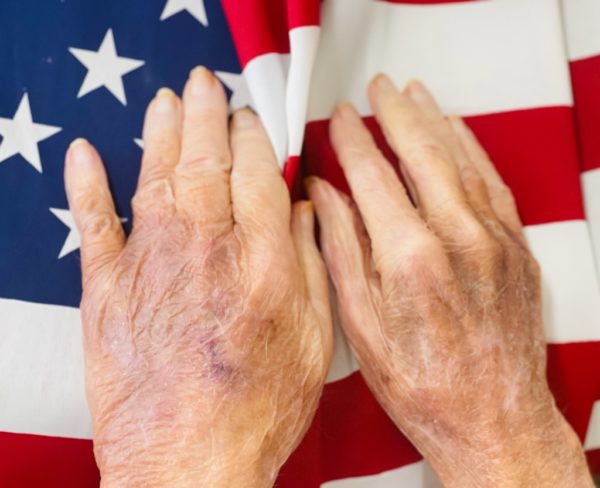 Hands on the US flag
