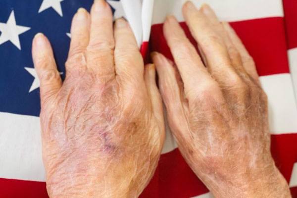 Hands on the US flag